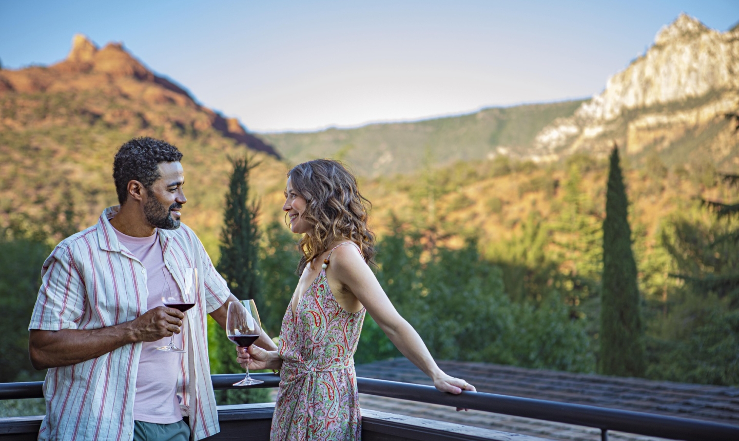 Couple with red wine on the balcony