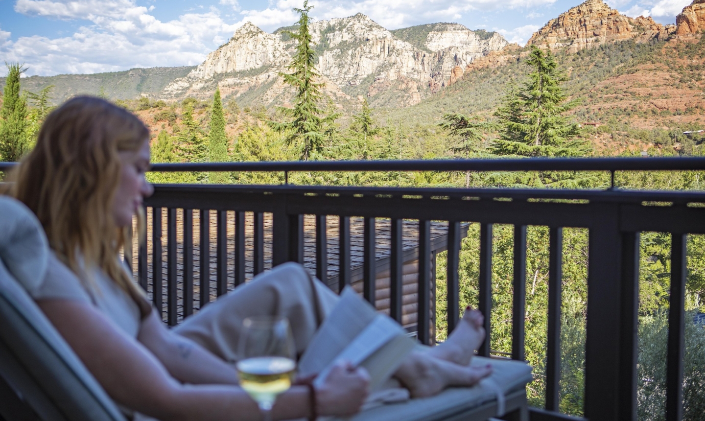 Woman reading a book on the balcony